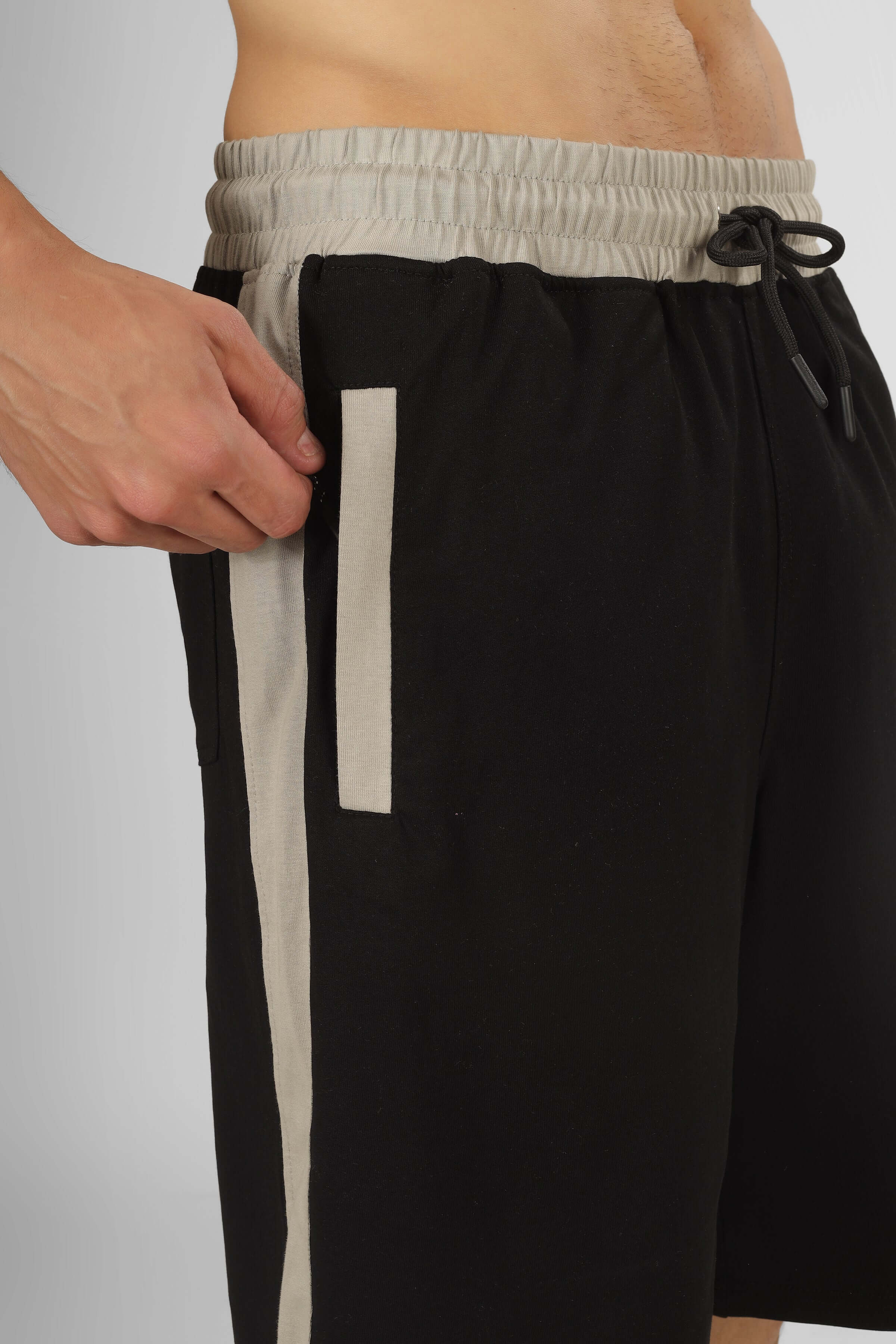 Close-up of black Pluto Contrast Regular Fit Shorts showcasing side detail and drawstring.