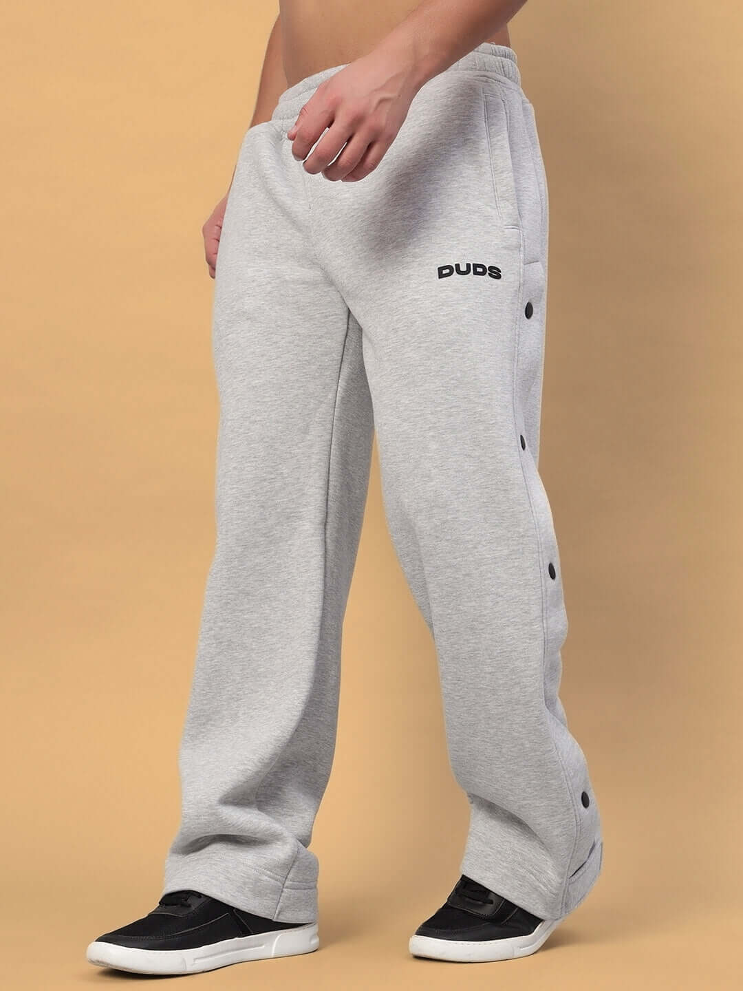 Man wearing POLAR Cotton Fleece Jogger in Grey with button details, showing comfort and style, paired with black sneakers, perfect for casual wear.
