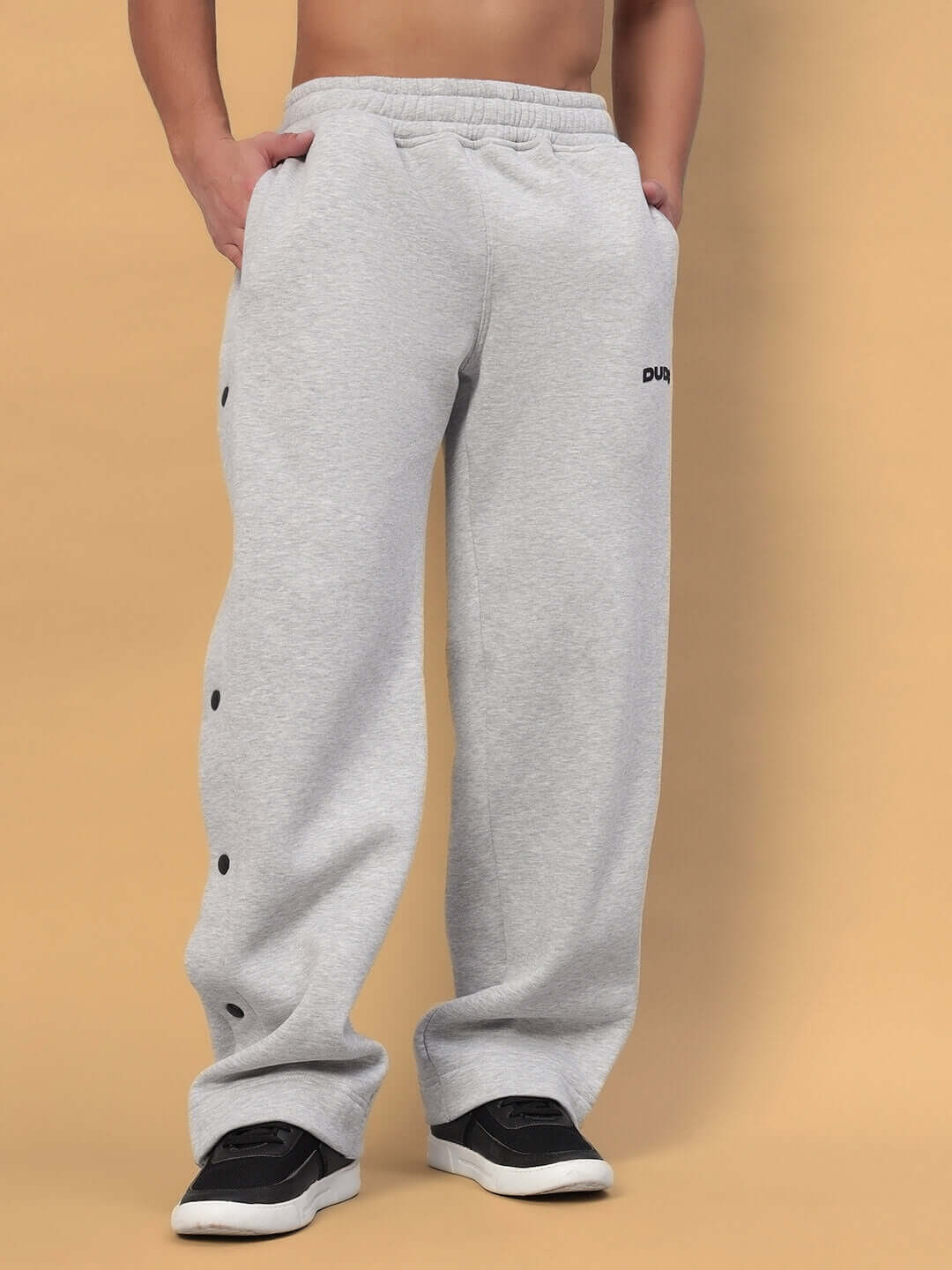 Man wearing POLAR Cotton Fleece Jogger in grey with button details, perfect for casual and athletic wear.