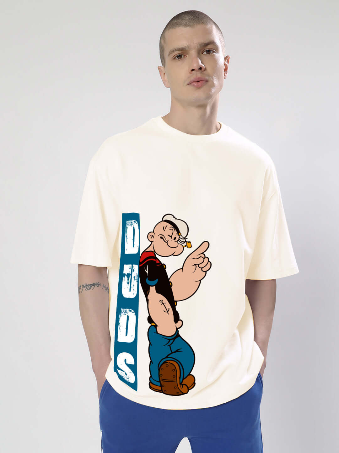 Cream Popeye oversized t-shirt by DUDS, featuring a nostalgic cartoon design. Custom fit available, handmade with dedication.