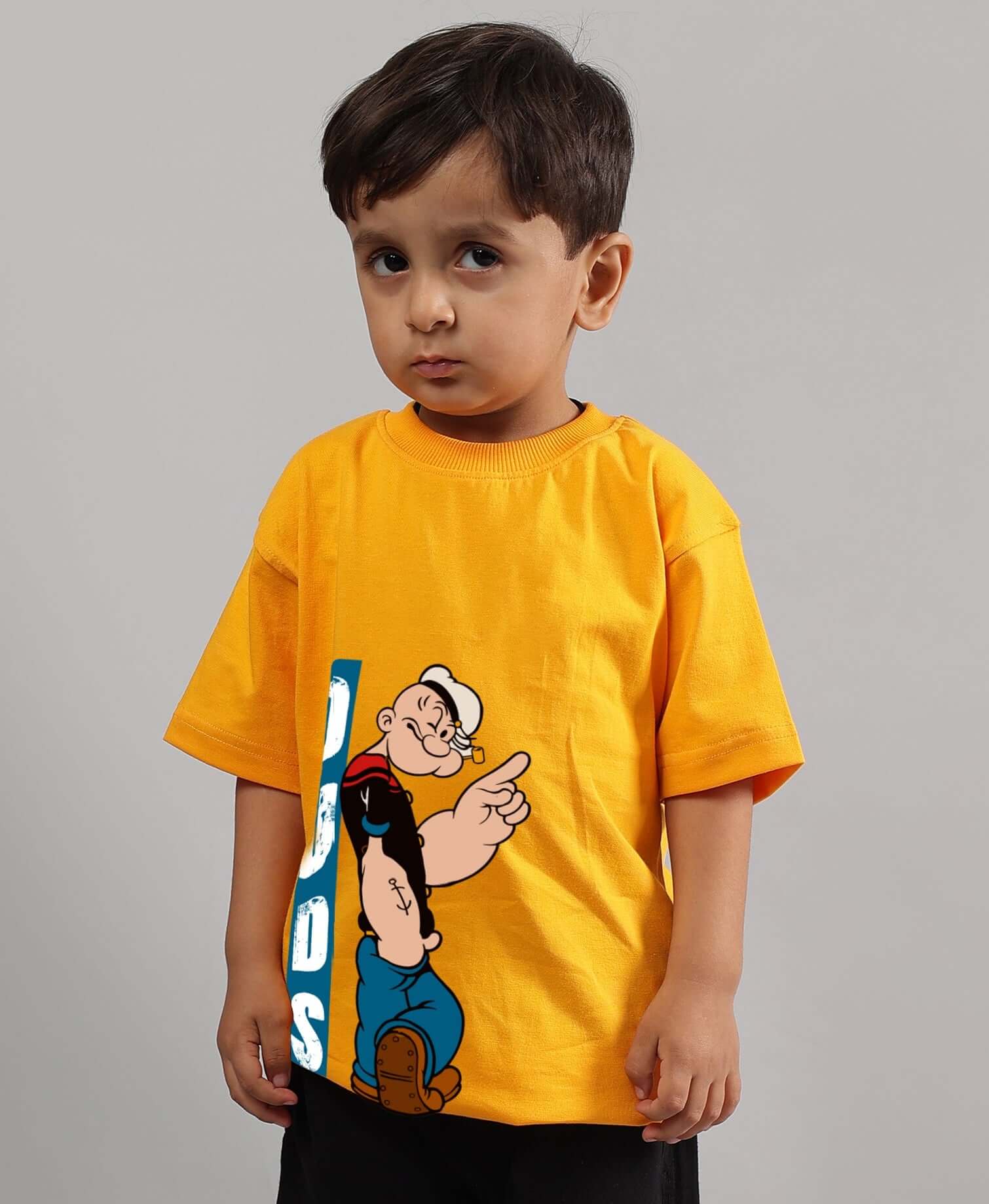 Child wearing a yellow Popeye T-shirt for boys and girls, customizable size option, made by experienced tailors at DUDS.
