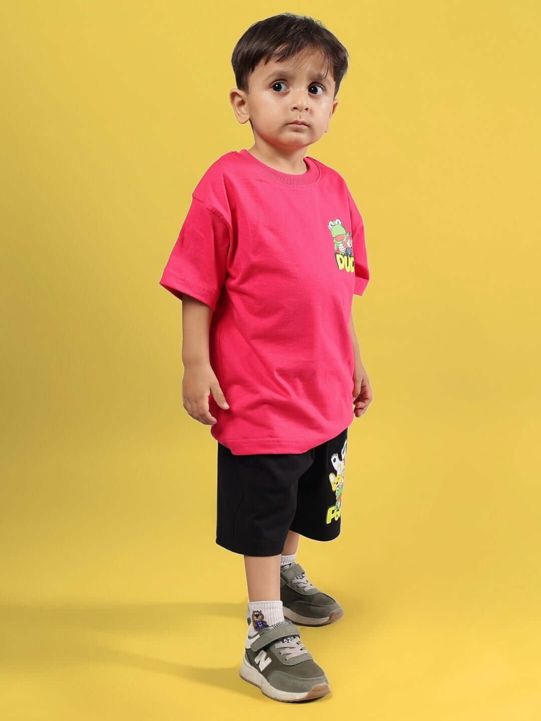Child wearing PORORO CO-ORD FOR BOYS & GIRLS PINK-BLACK outfit consisting of a pink t-shirt and black shorts.
