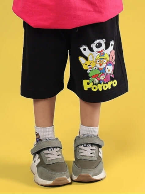 Child wearing Pororo themed black shorts by DUDS, featuring colorful cartoon characters, suitable for boys and girls.