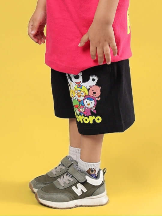 Child wearing Pororo shorts in black, showcasing colorful character print, ideal for boys and girls. Customizable fit available. 