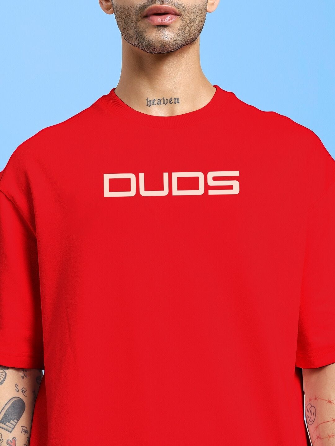 Model wearing PORSCHE PRINTED OVER-SIZED T-SHIRT RED with bold print, showcasing streetwear style and relaxed fit.