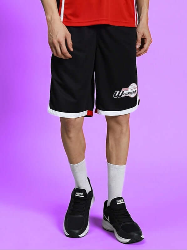 Model wearing Portia Regular Fit Black Shorts showcasing athletic casual style against a purple background.