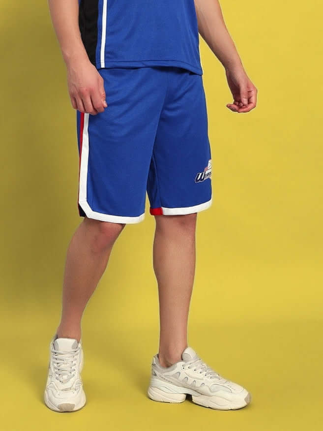 Man wearing PORTIA REGULAR FIT SHORTS ROYAL BLUE with sporty design, perfect for workouts or casual wear.