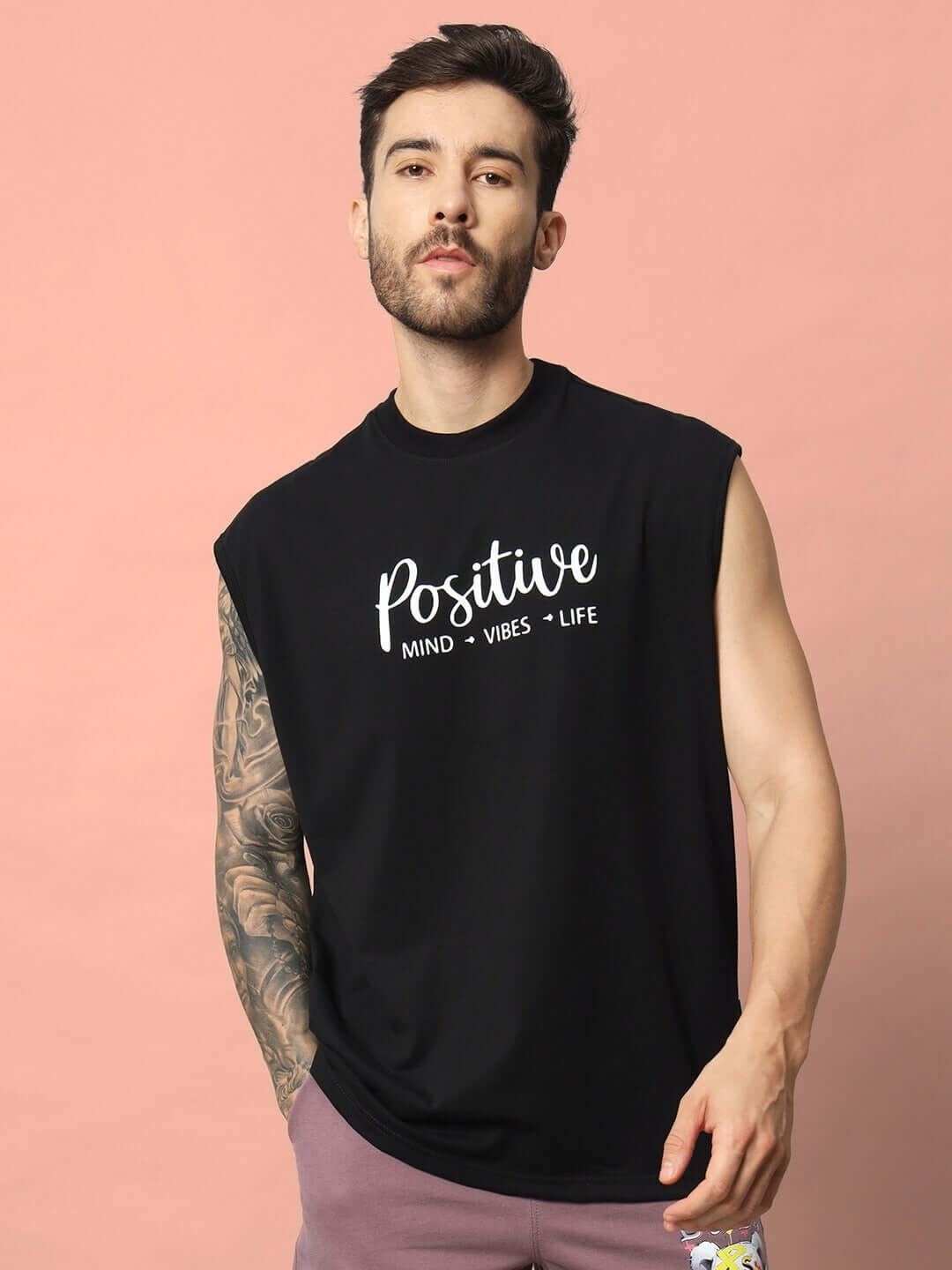 Black sleeveless Positive Life gym t-shirt featuring motivational text 'Positive Mind Vibes Life' worn by a model.