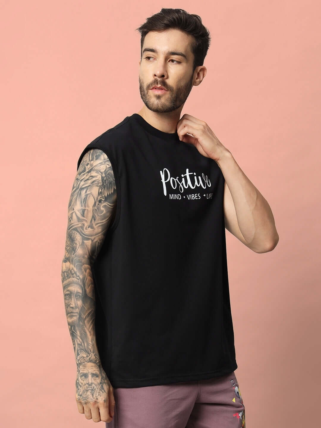 Man wearing a black Positive Life gym t-shirt with motivational text, featuring custom fit option and handmade craftsmanship.