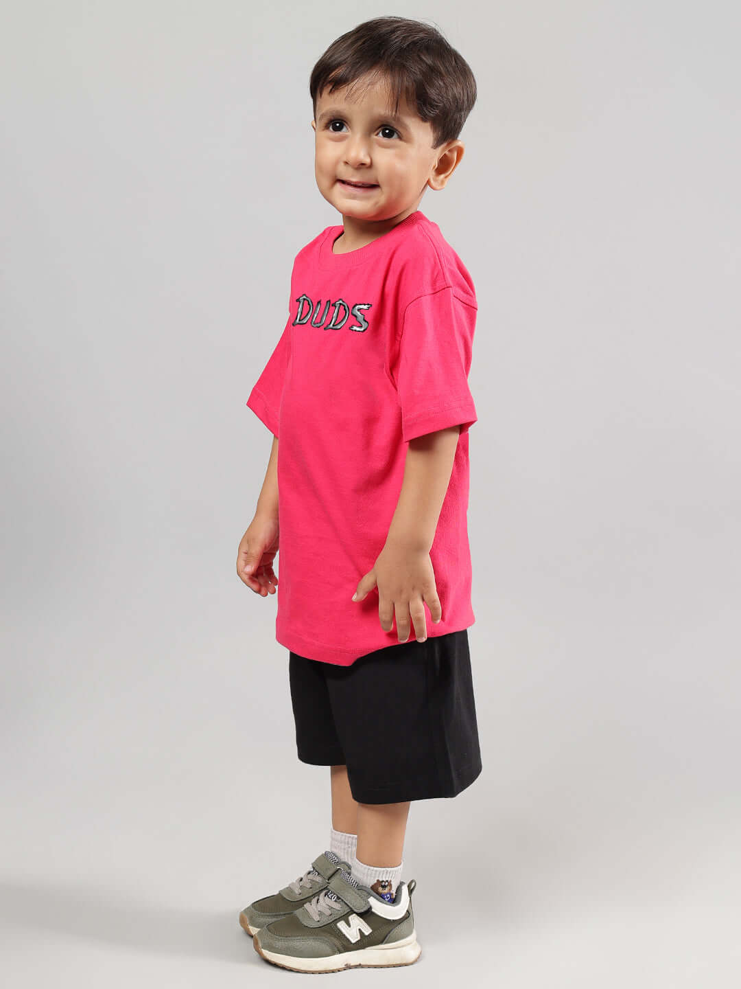 POSITIVE RABBIT KIDS CO-ORD FOR BOYS GIRLS PINK-BLACK outfit featuring a smiling child in pink top and black shorts.