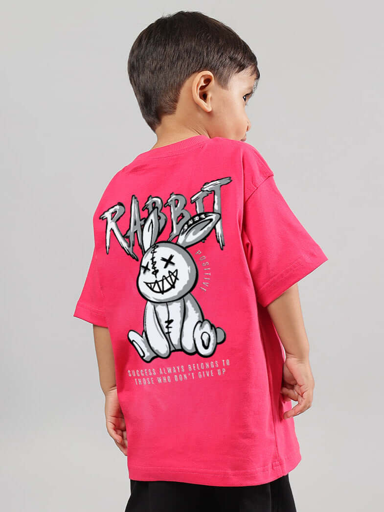 Boy wearing pink Positive Rabbit T-shirt with rabbit graphic, perfect for girls and boys, custom fit options available - DUDS