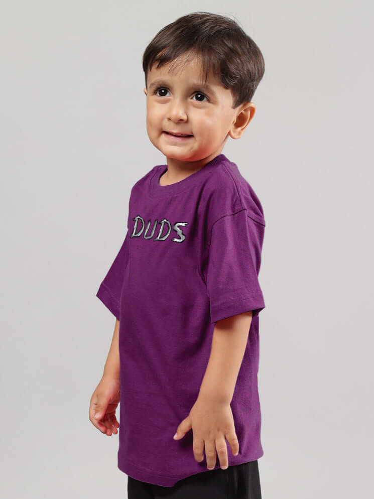 Child wearing a purple 'DUDS' rabbit T-shirt, suitable for boys and girls, showcasing a positive and playful design.