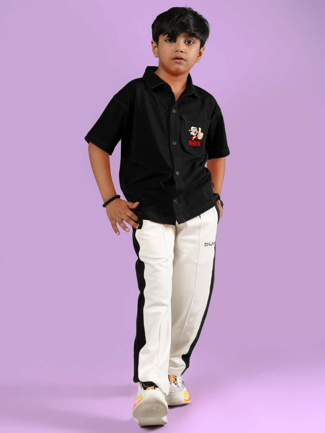 Boy wearing POWER KIDS CO-ORD FOR BOYS & GIRLS BLACK-OFF-WHITE, featuring black shirt and white pants with black stripes, stylish outfit for kids.