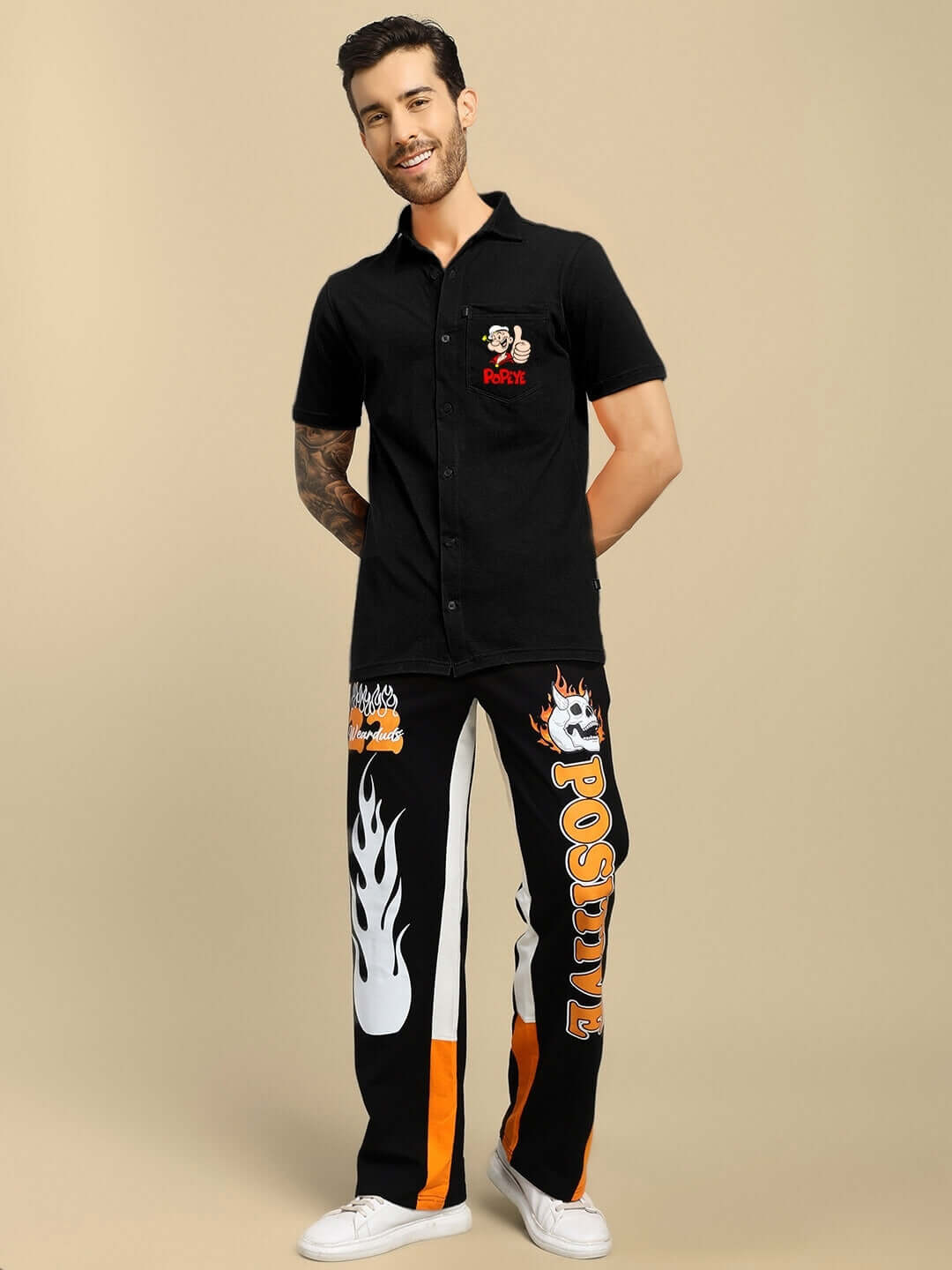 Man wearing black POWER MEN Popeye printed shirt, custom-fit option, by DUDS, demonstrated against a neutral background.
