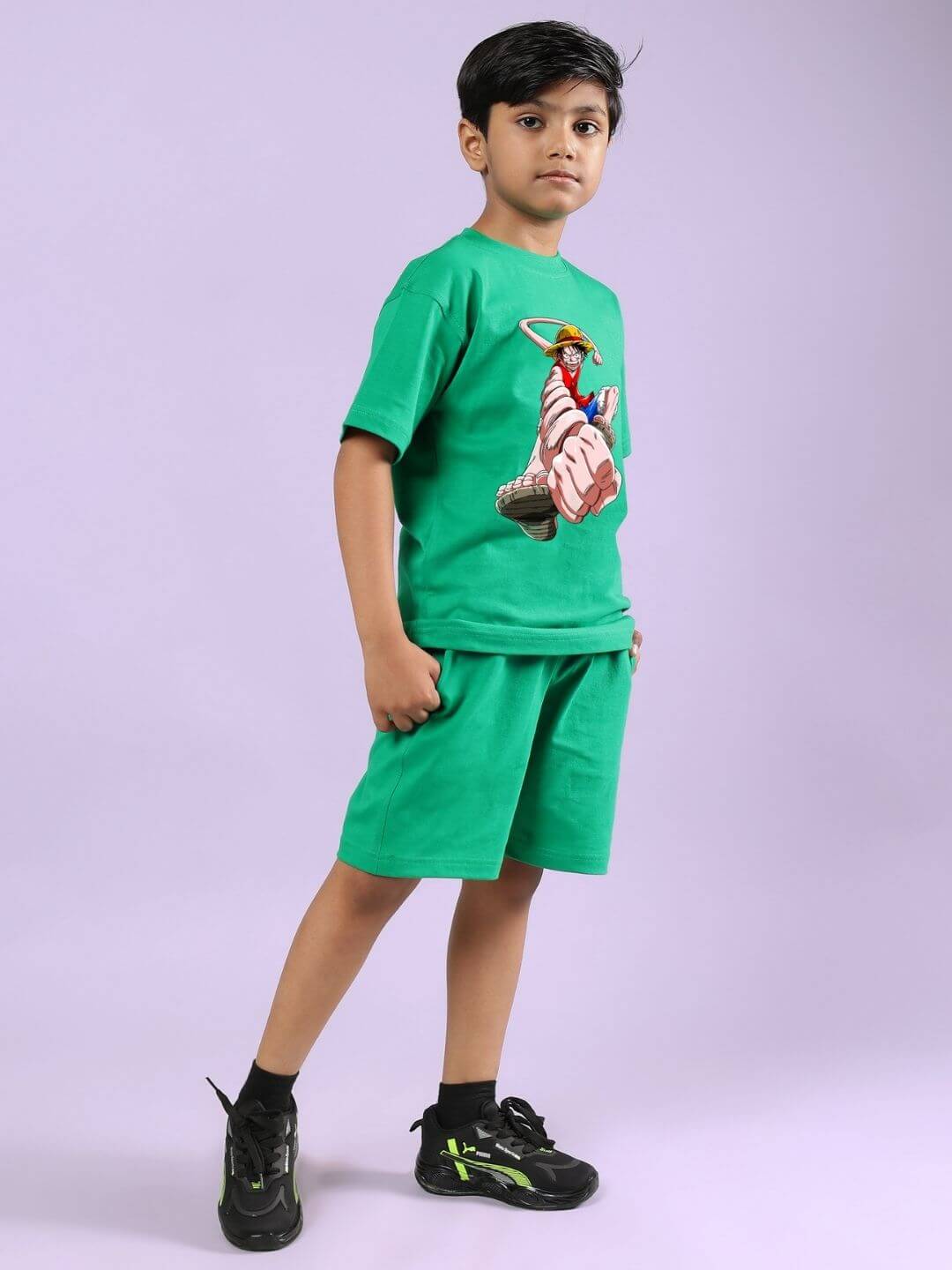Child wearing green Power Punch Co-Ord set, featuring a graphic top and shorts, for boys and girls, against a neutral background.