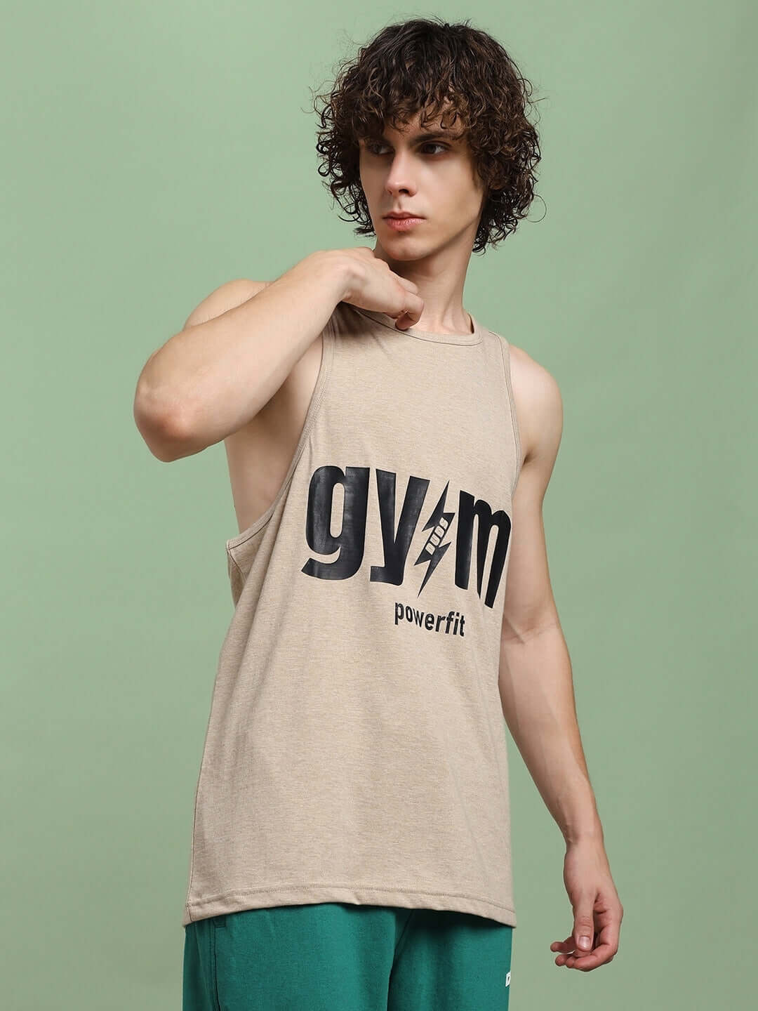 Model wearing a beige Powerfit Fitness Gym T-shirt, featuring large 'gym' print, designed for custom fit options. Perfect for workout sessions.