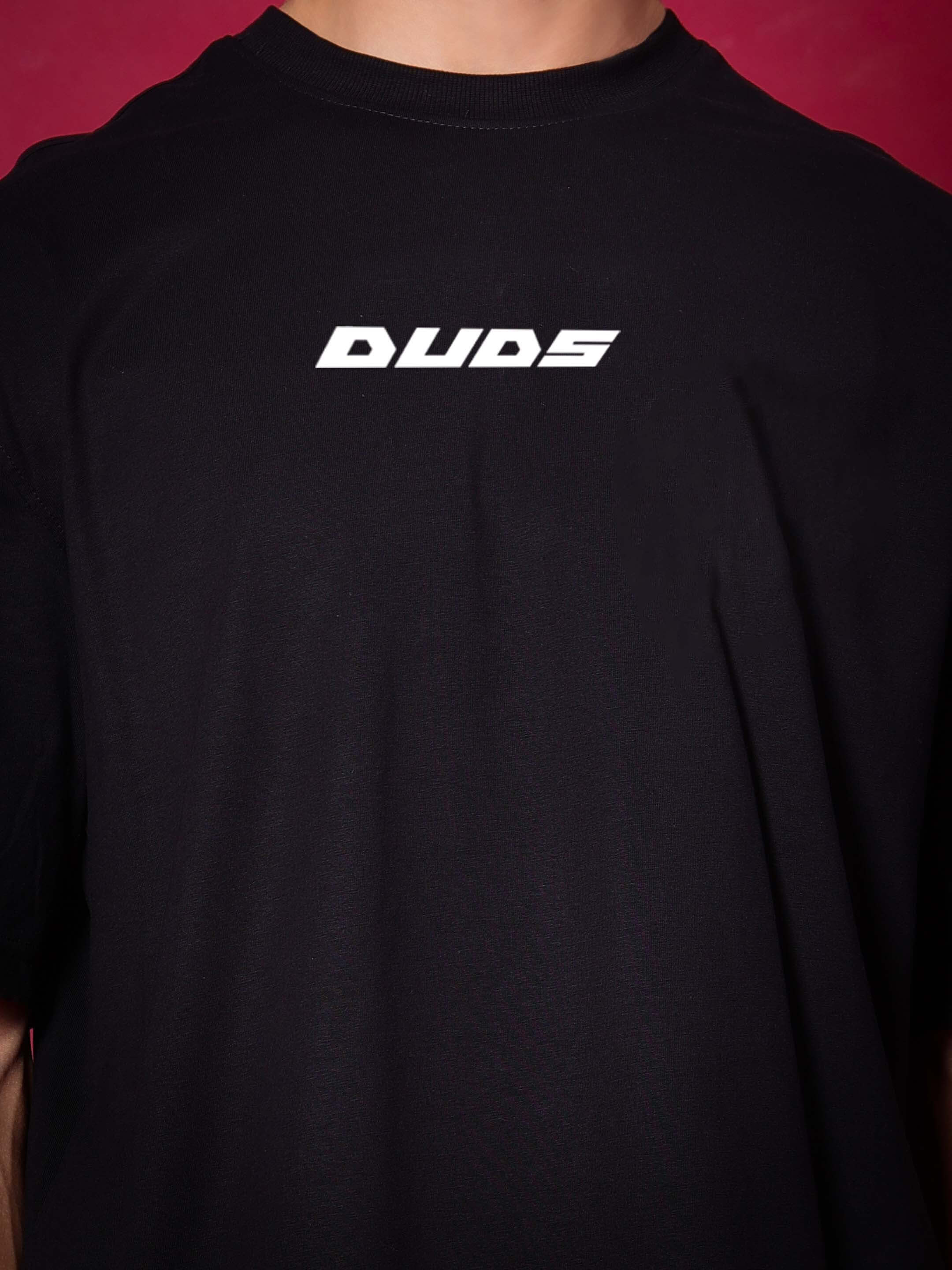 Black over-sized t-shirt with 'DUDS' logo, made from premium cotton French terry, featuring a crew neckline; ideal for casual wear.