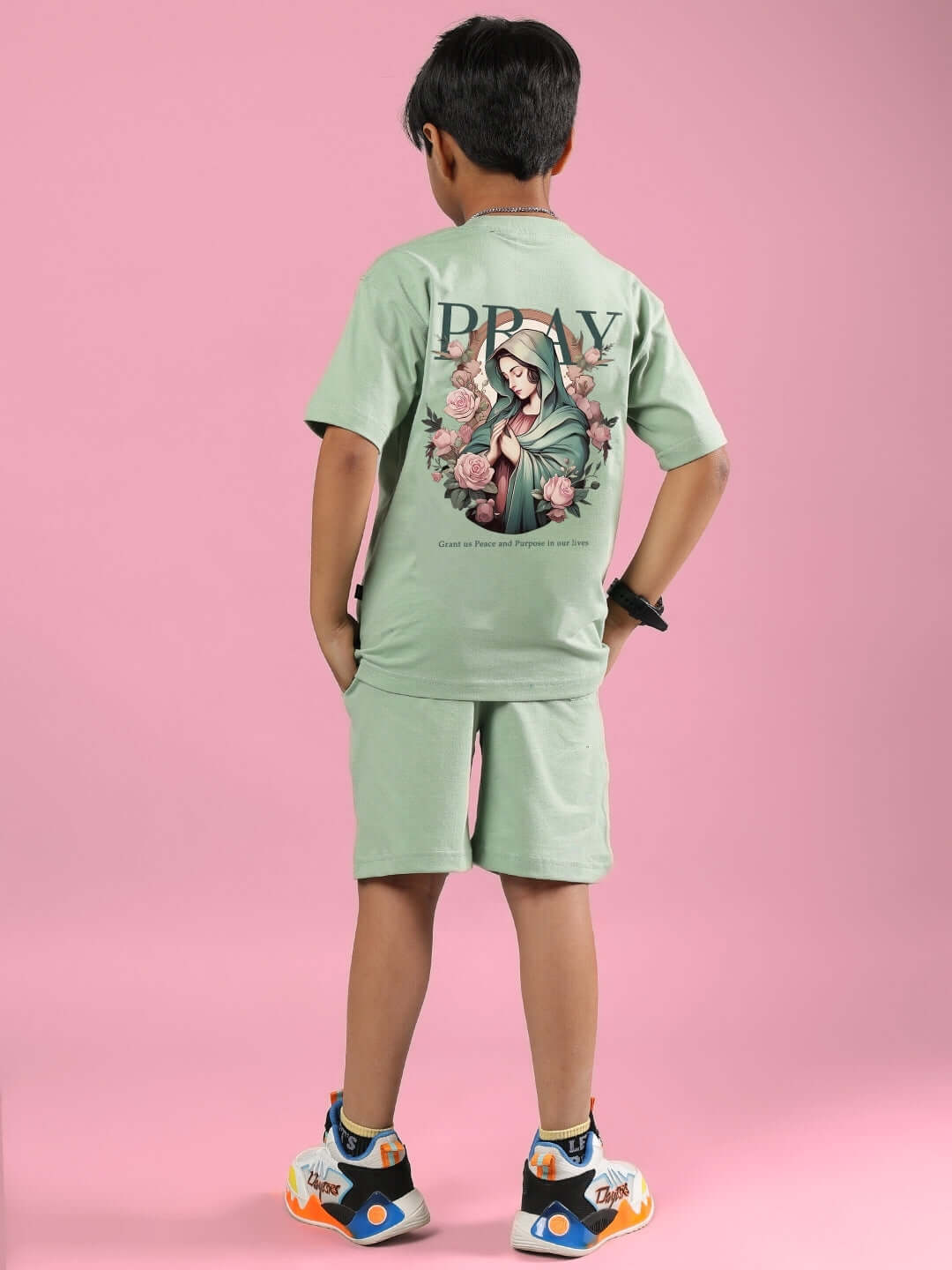 Child wearing Nyanza Green Pray & Peace co-ord set with graphic design, showcasing trendy casual fashion for boys and girls.