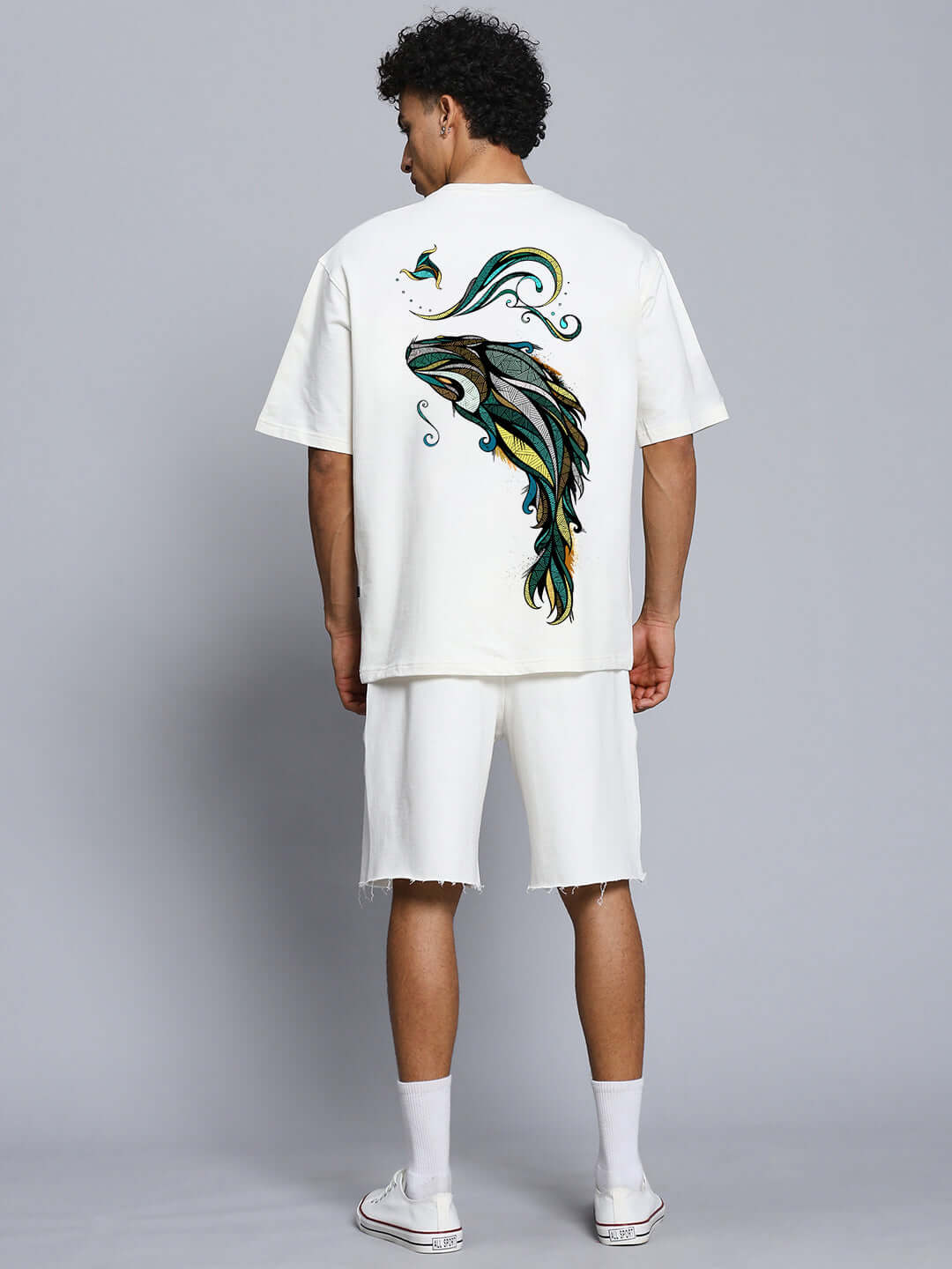 Person wearing PREMIUM FISH PRINT CO-ORD SET in off white showing fish design on back, made of cotton French terry blend with 240 GSM.