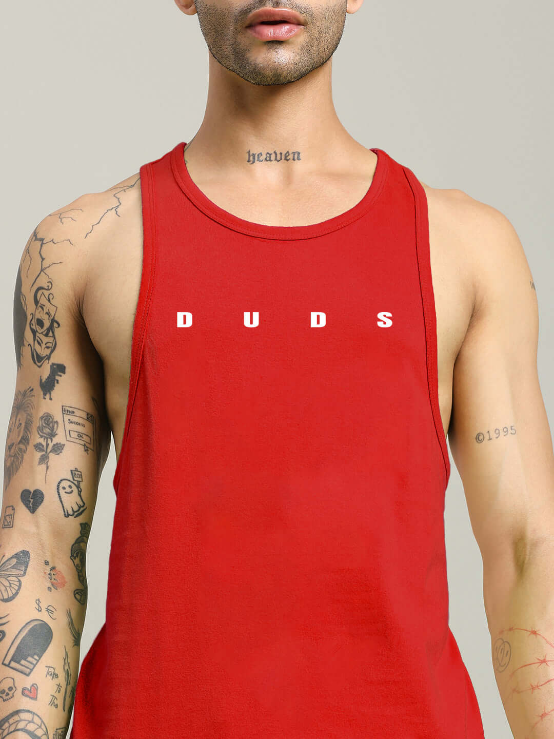 Man wearing Primo Gym T-Shirt Red Premium Workout Tee with tattoos on arms and chest.