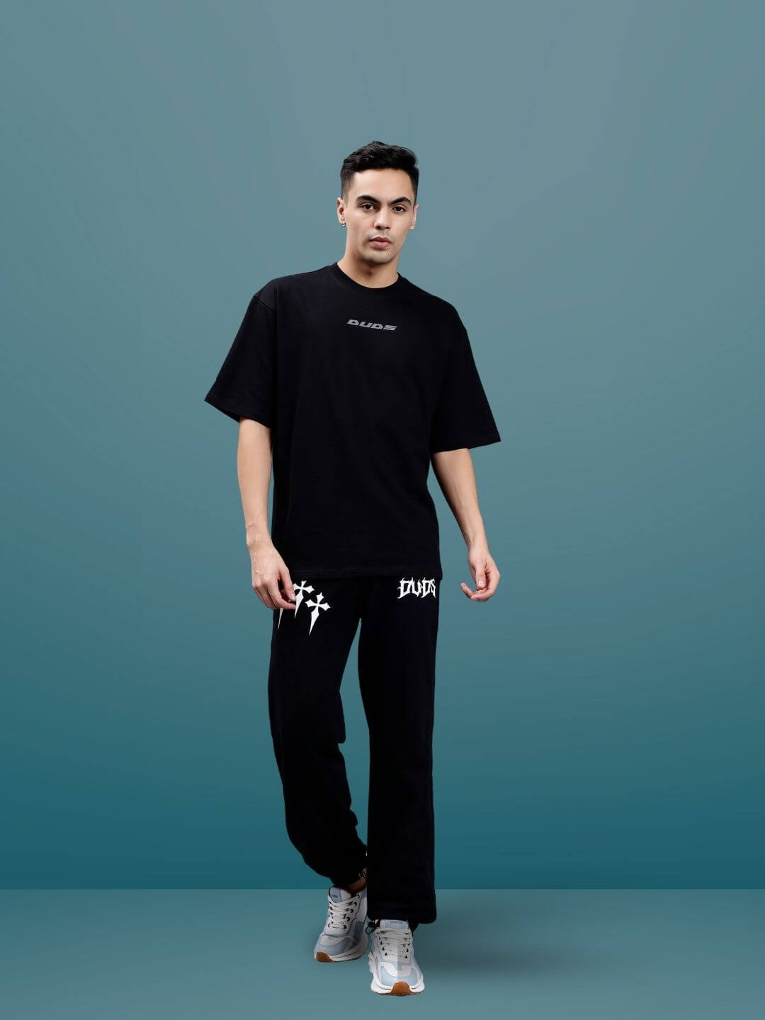 Model wearing Pulsating Rhythms Reflector Over-Sized T-Shirt in black, showcasing premium cotton fabric. Made in India, cold wash care.