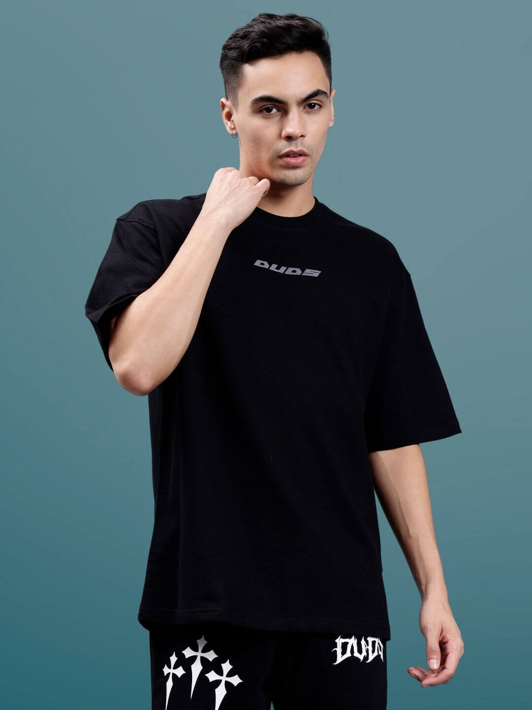 Model wearing Pulsating Rhythms Reflector Over-Sized T-Shirt in black, made from premium cotton and elastane blend, 240 GSM, by Color By.