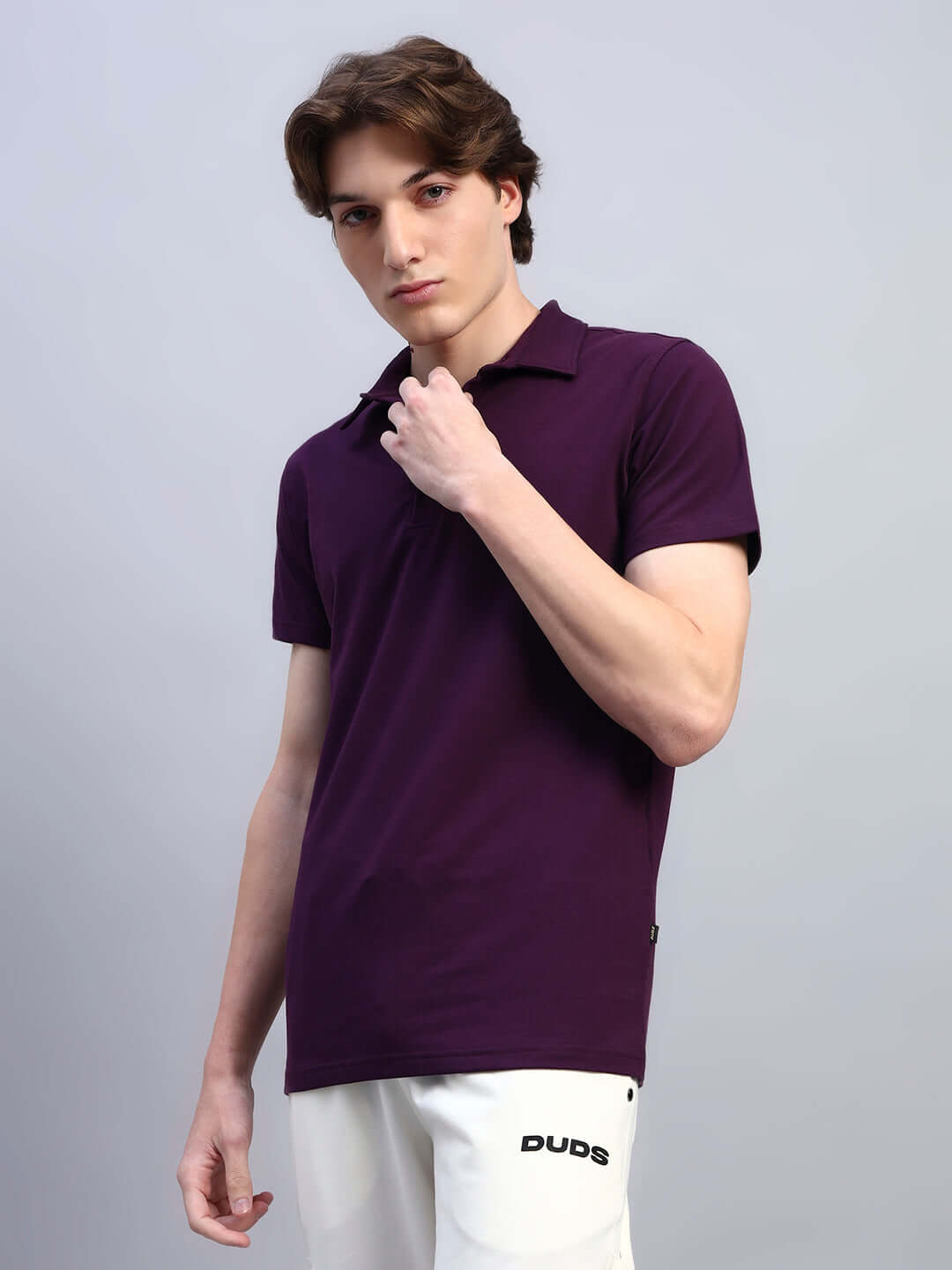 Young man wearing WIDEL REGULAR FIT T-SHIRT PURPLE showcasing style and comfort.