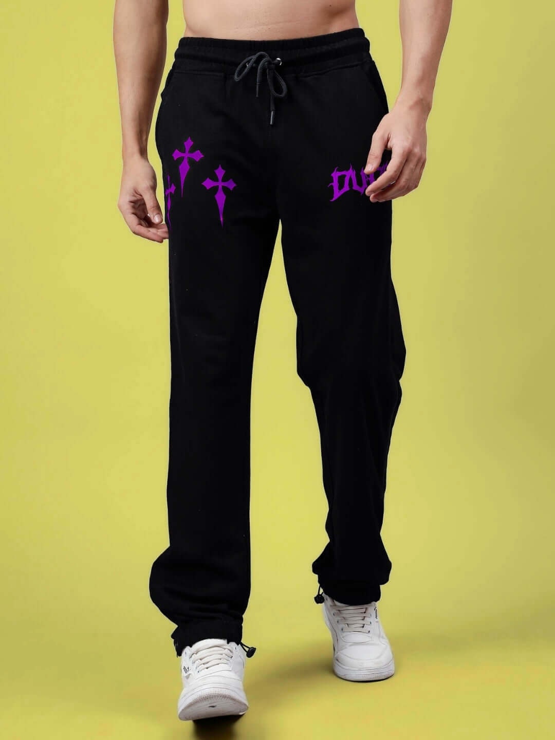 Man wearing black zipper panel joggers with purple design, showcasing style and flexibility in casual wear.