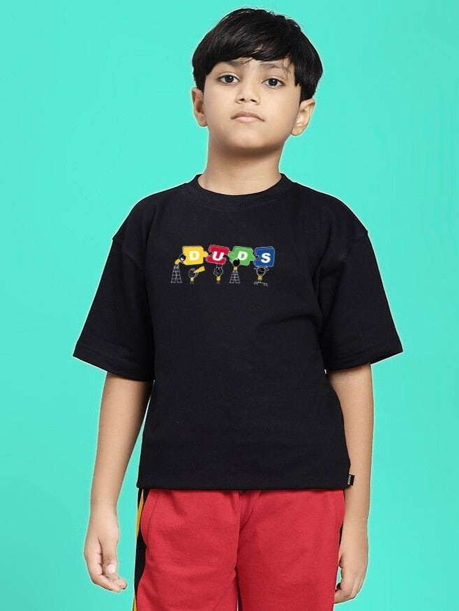 PUZZEL T-SHIRT FOR BOYS AND GIRLS BLACK worn by a boy on a teal background.