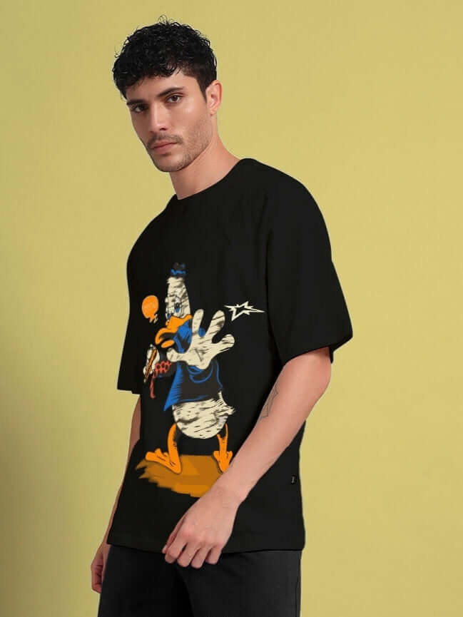 Model wearing QUACK OFF oversized black t-shirt with cartoon duck graphic, ideal for trendy and comfy summer fashion.