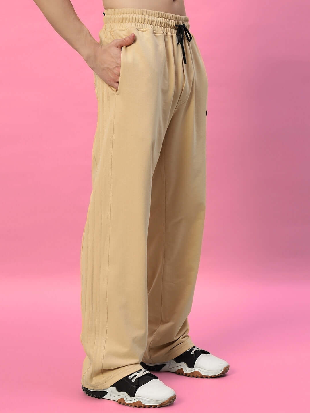 Beige Quantum Relaxed-Fit Joggers displayed against pink background, highlighting casual and comfortable style with elastic waistband.