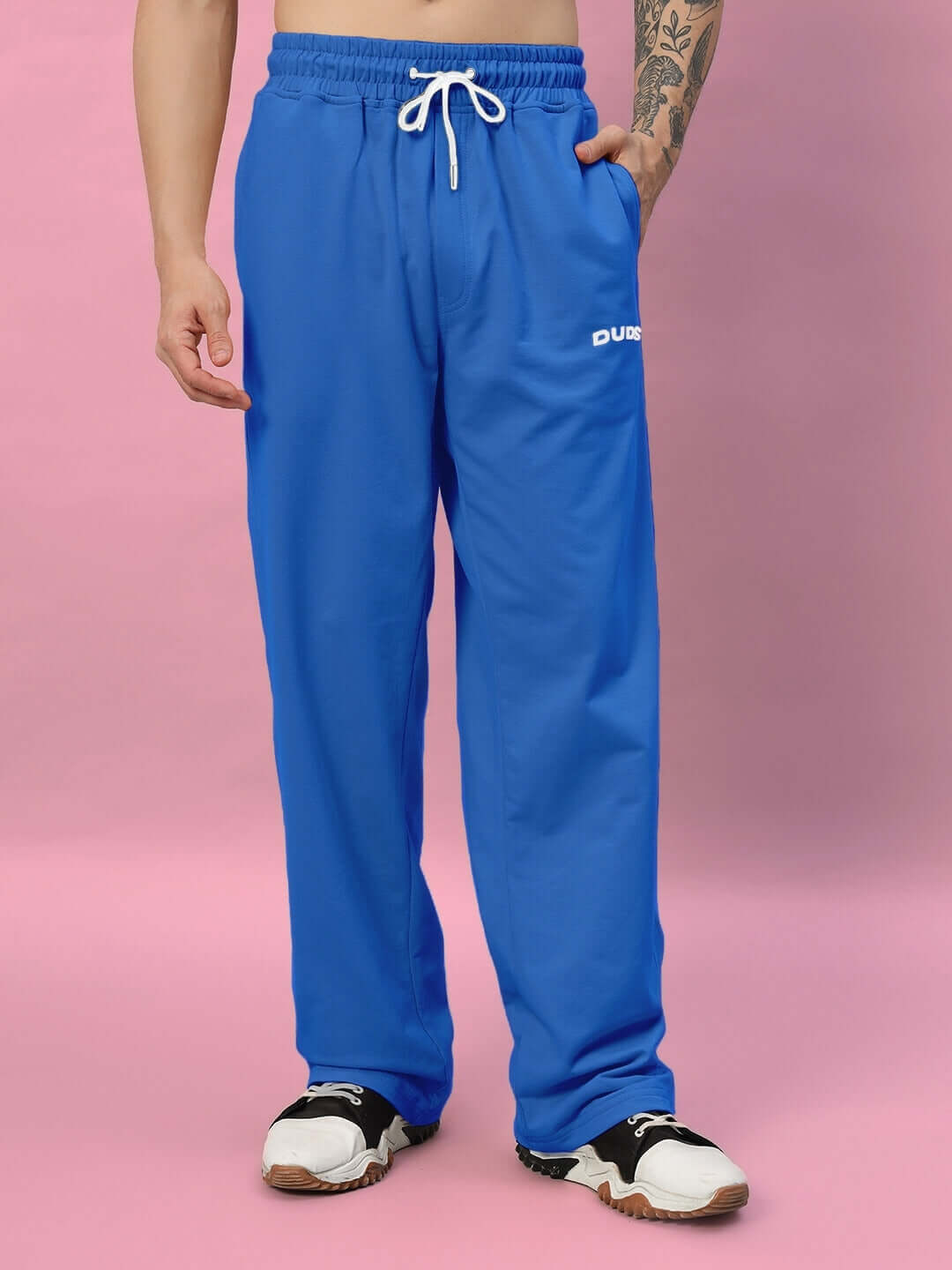 Model wearing blue Quantum relaxed-fit joggers by DUDS with a drawstring waist, made for comfort and style.