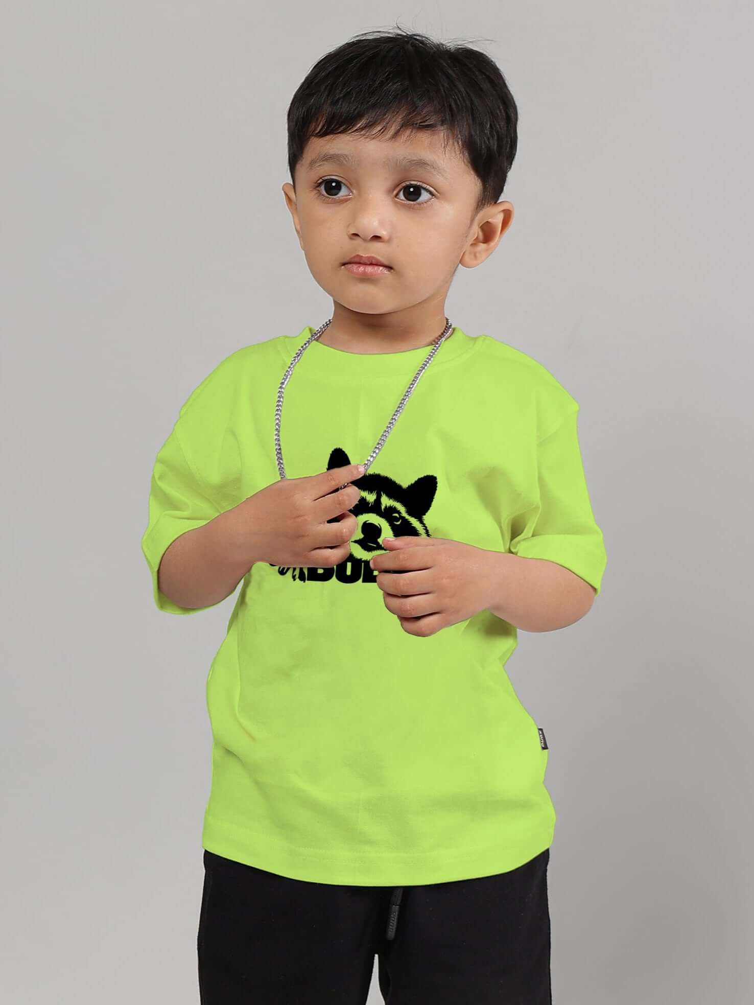 Child wearing a neon green raccoon graphic t-shirt for boys and girls, featuring short sleeves and a playful design.