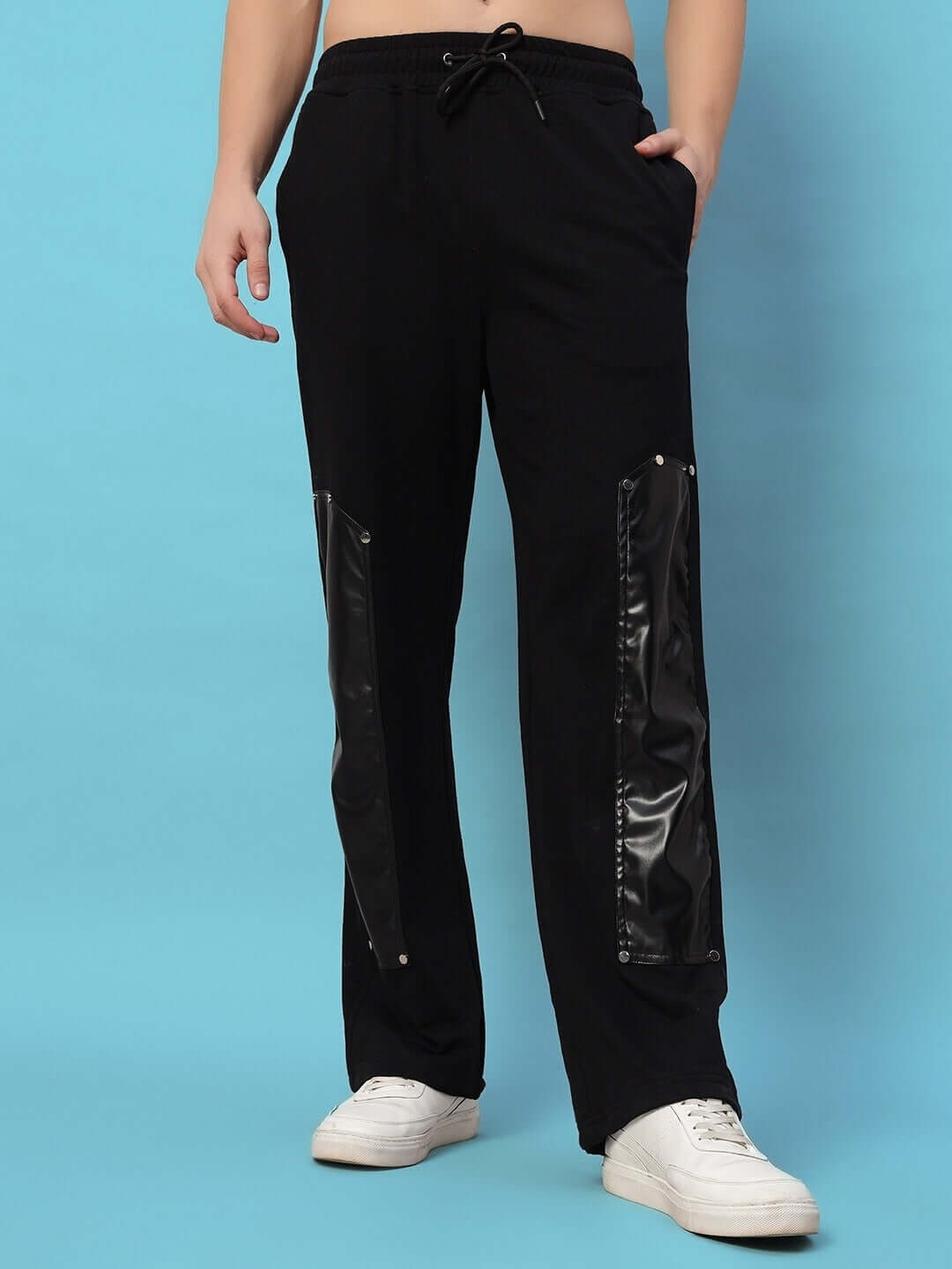 Black joggers with raccoon leather patches, featuring a customizable fit option for a tailored look.
