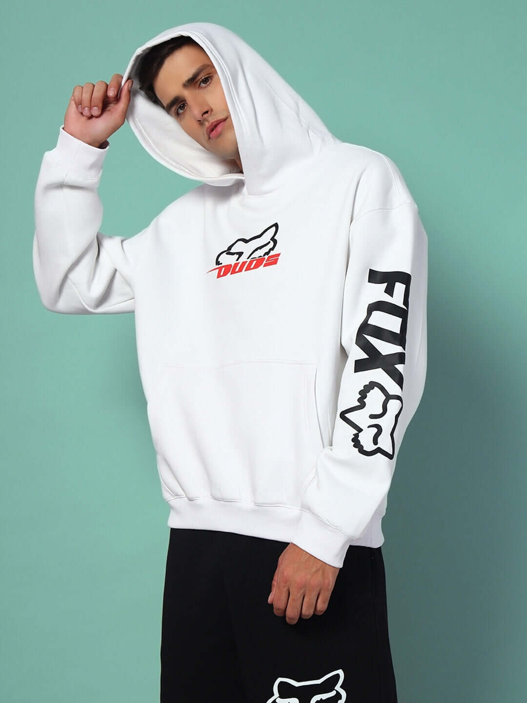 Man wearing RACING FOX FLEECE CO-ORD WHITE BLACK hoodie, showcasing sleek colorblock streetwear style.
