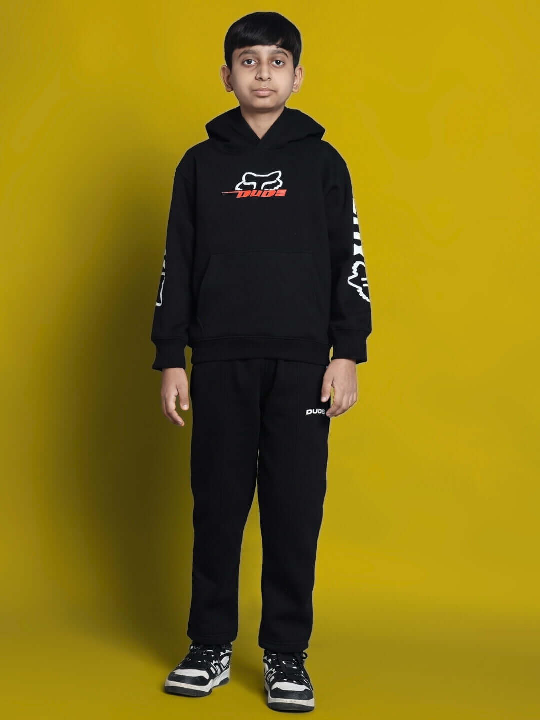 Boy wearing Racing Fox oversized black hoodie with racing graphics, perfect for boys and girls. Streetwear style, cozy fabric.