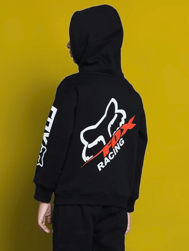 Child wearing Racing Fox oversized black hoodie with bold logo design. Suitable for boys and girls. Fashionable streetwear style.