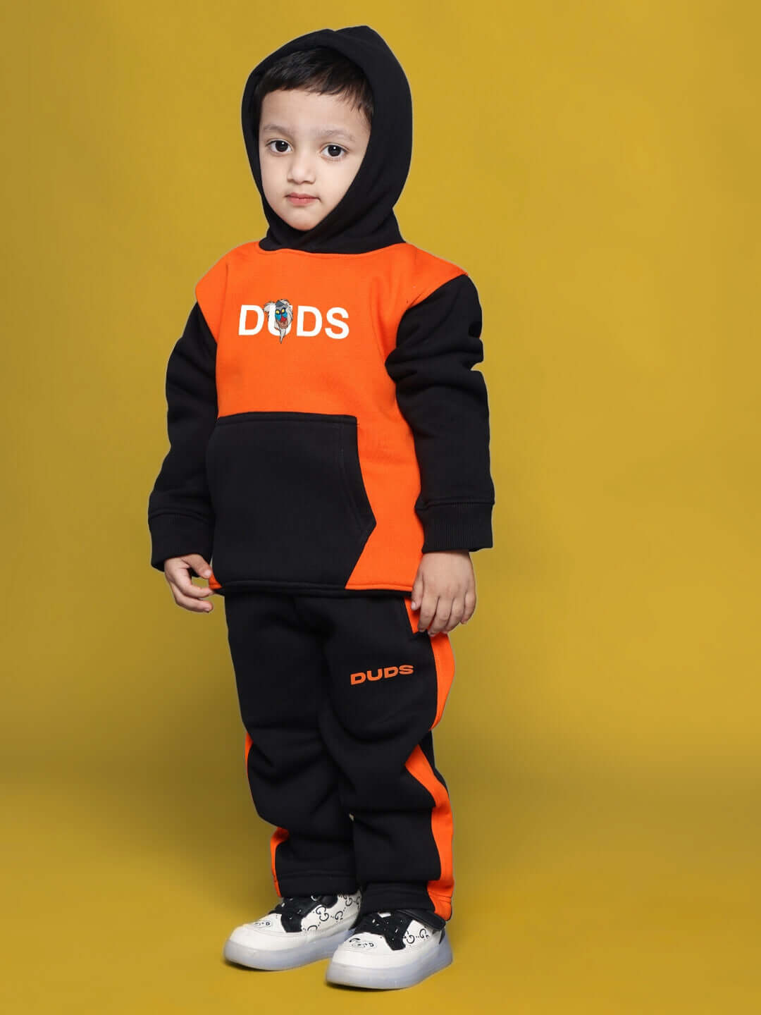 Child wearing RAFIKI CO-ORD FOR BOYS GIRLS BLACK ORANGE outfit, featuring black and orange colors, designed for comfort and style.