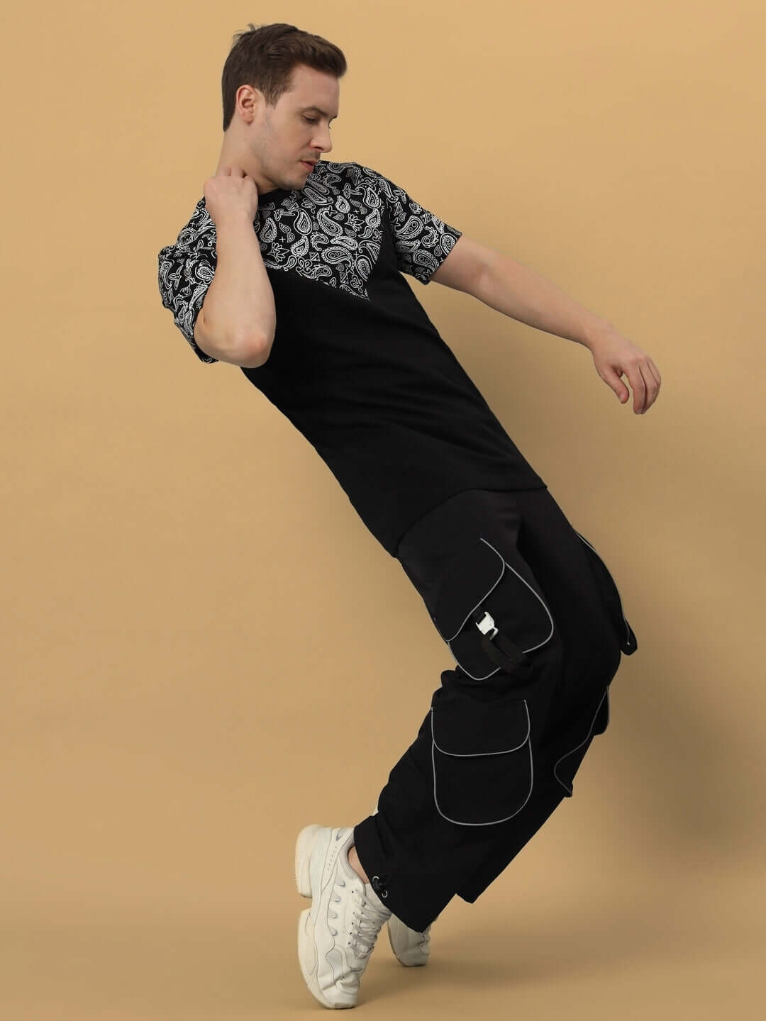 Model wearing Ragga Reflector Parachute Cargo Pants in Black, showcasing unique style with customizable fit options. DUDS handmade quality.