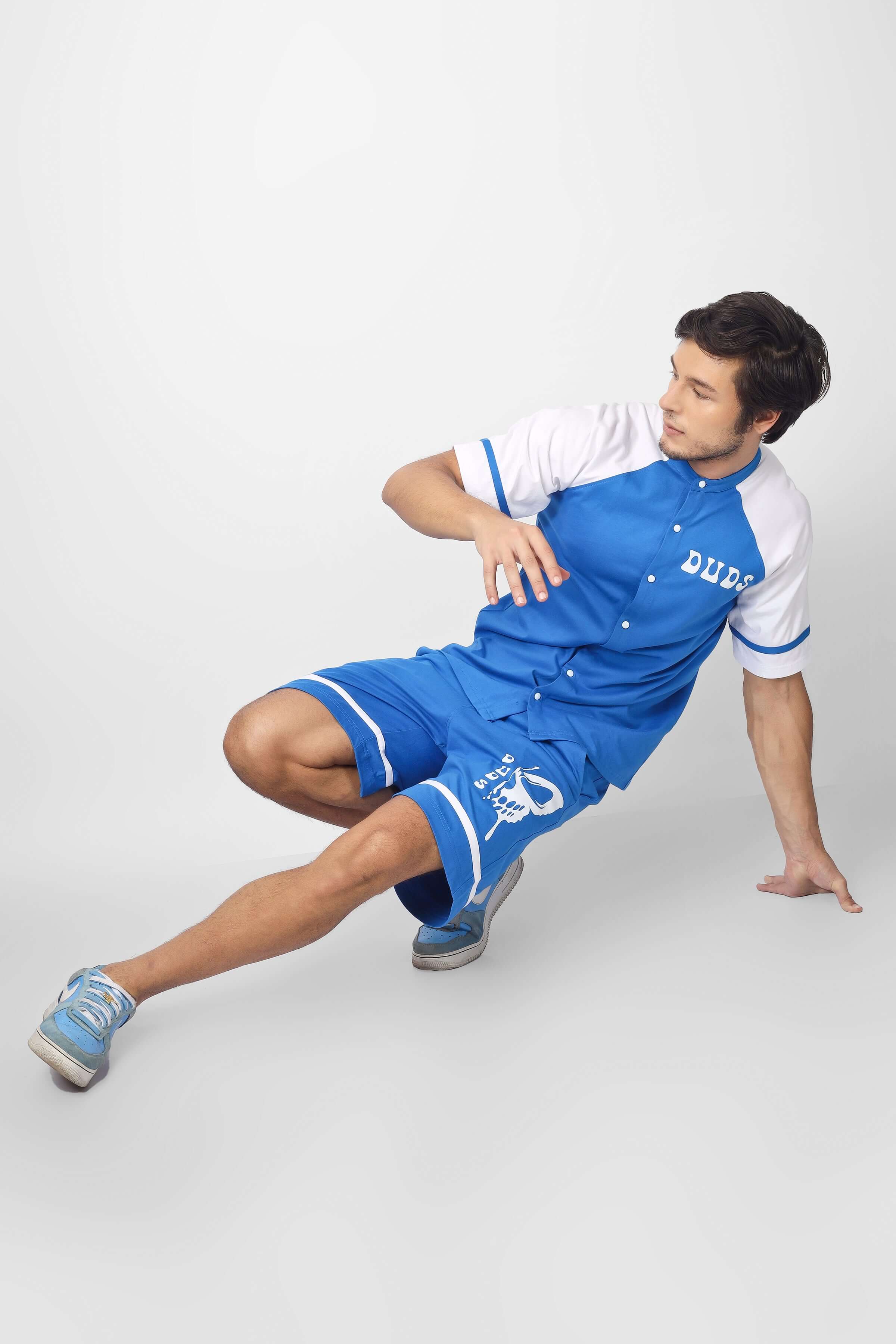 Model wearing RAGLAN OS T-SHIRT WITH SKULL BUTTERFLY PRINT BLUE, showcasing its artistic streetwear style.