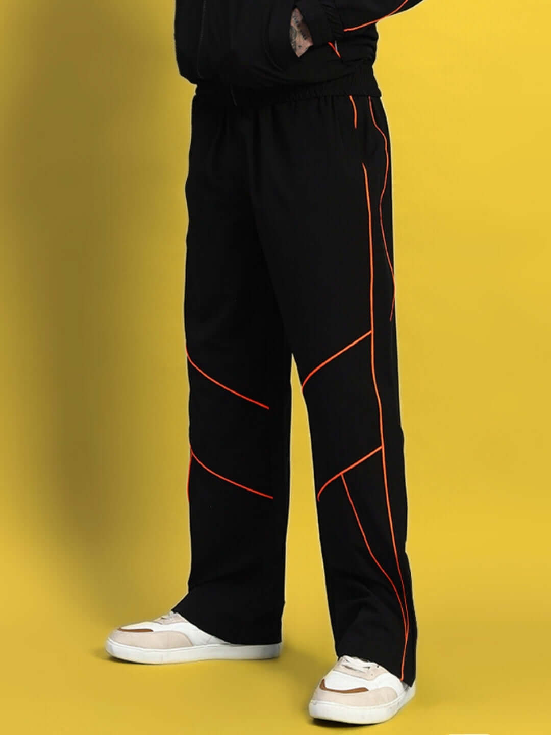 Black Raider Relaxed Pant Jogger with orange accents by DUDS, tailored fit option available, shown on a yellow background.