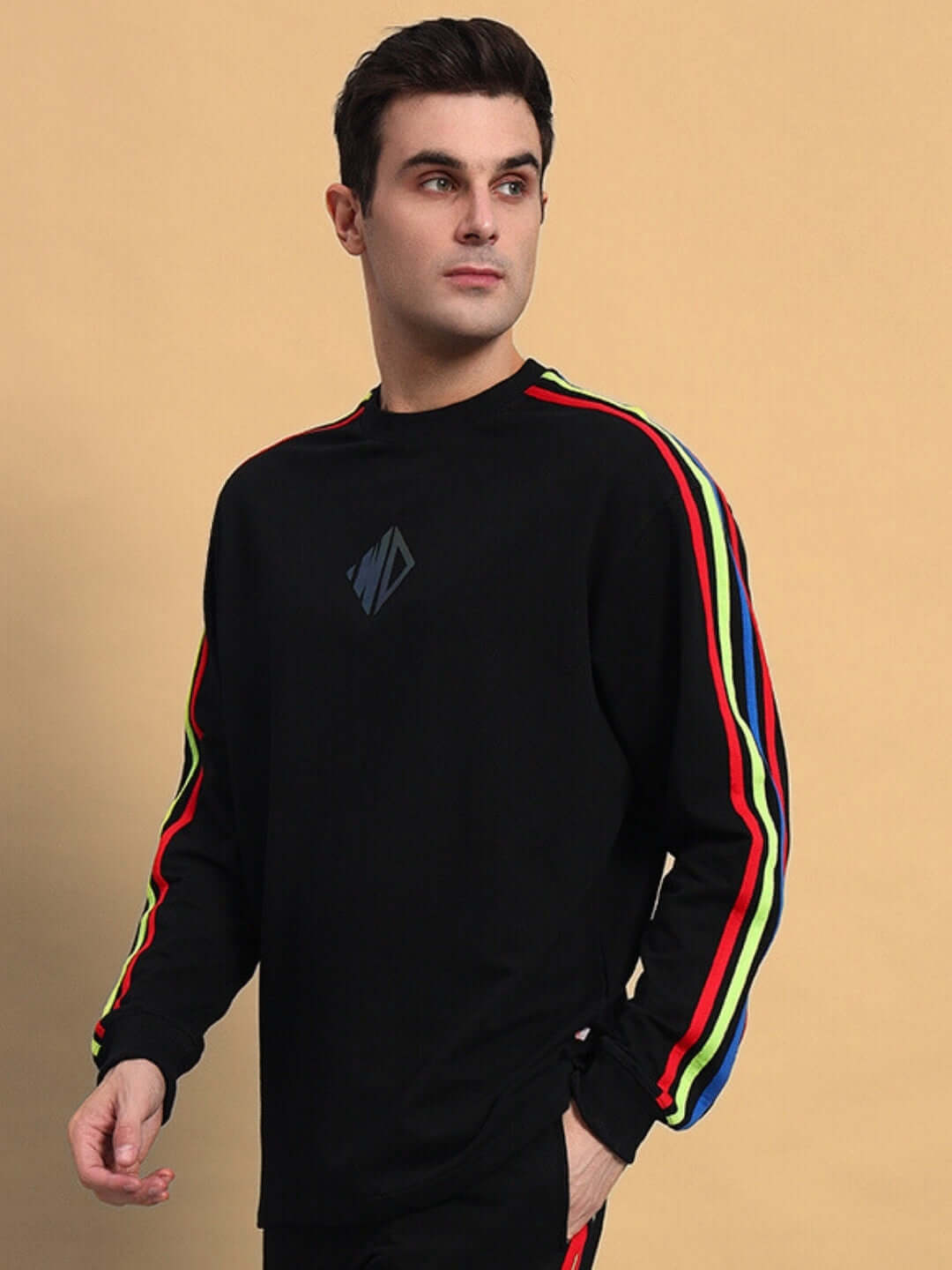 Model wearing RAINBOW OVERSIZED CO-ORD SET BLACK with colorful stripe detail, showcasing relaxed fit and stylish design.