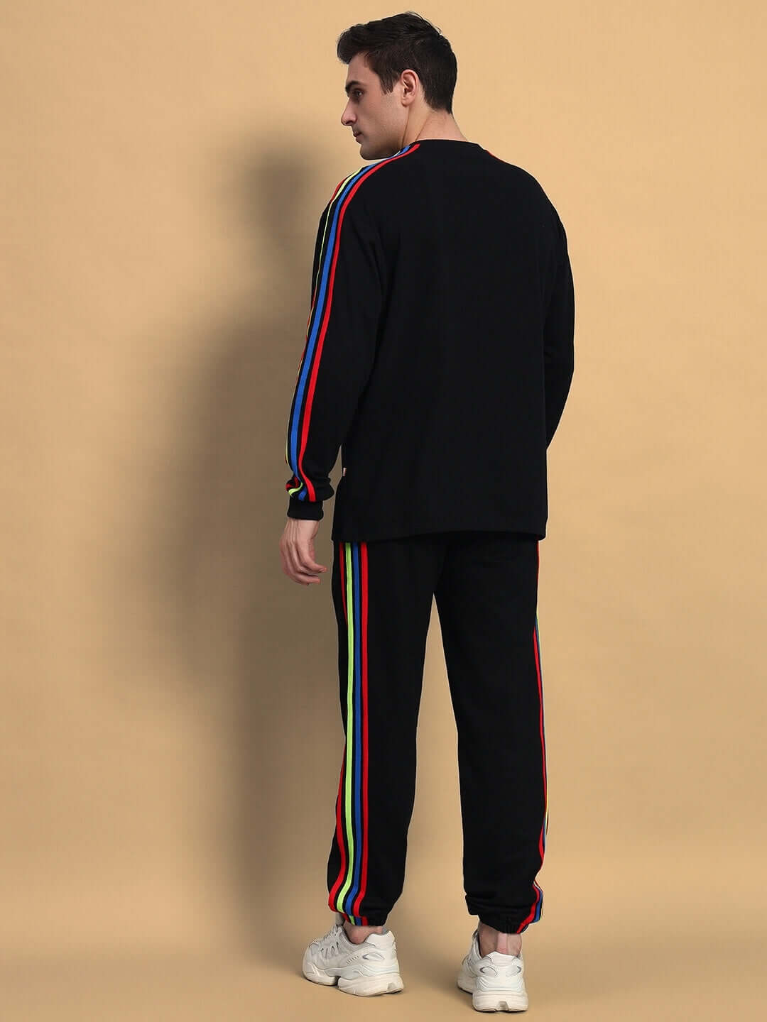 Back view of RAINBOW OVERSIZED CO-ORD SET BLACK showing colorful stripe detailing on black fabric.