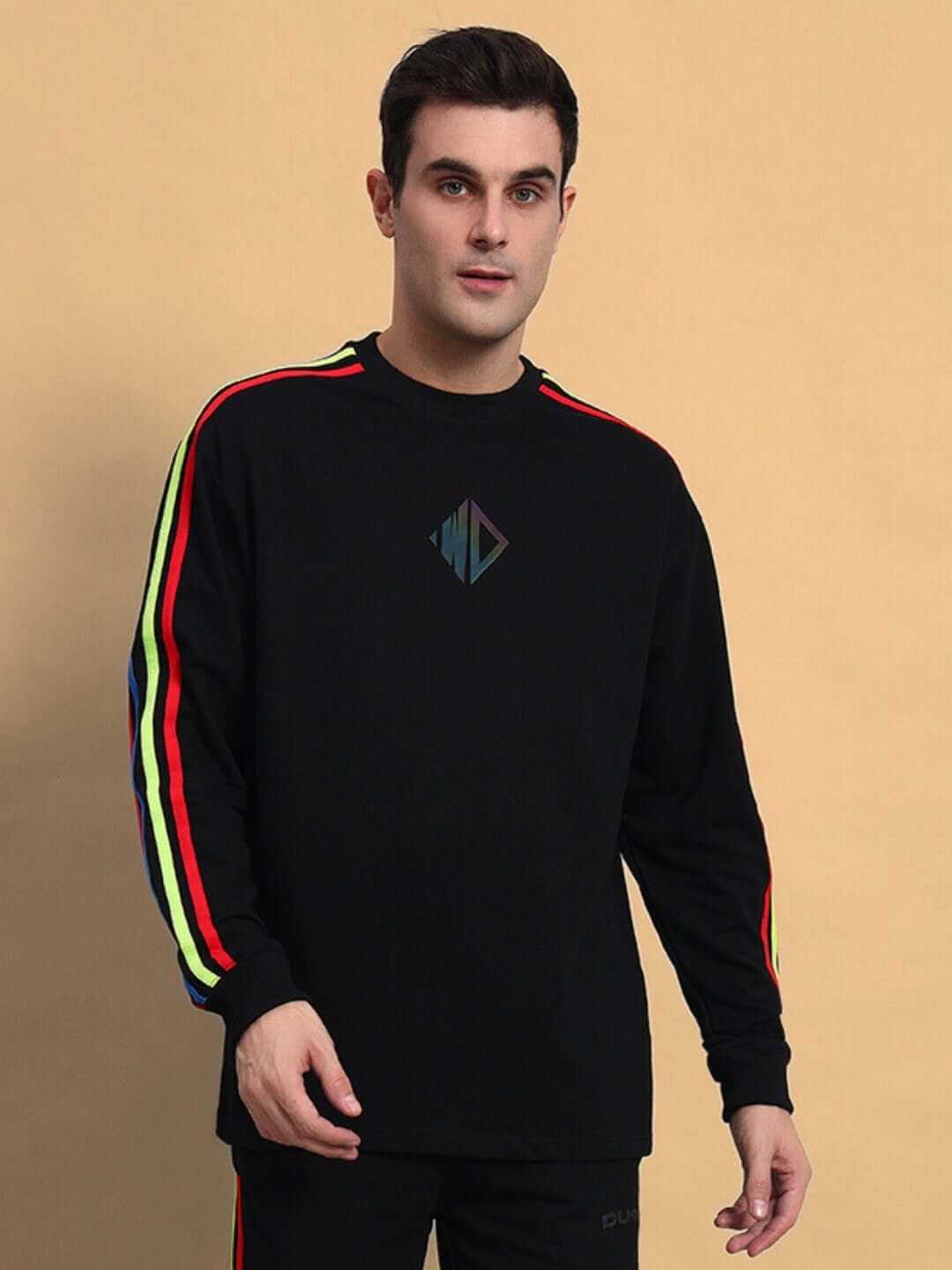 Man wearing black rainbow colorblock sweatshirt with stripe detail, made by DUDS, customizable size option available.