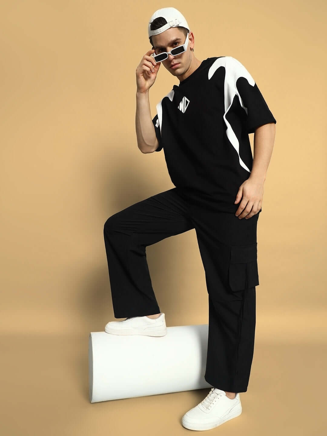 Model wearing Ramrod Parachute Cargo Pants in black, styled with casual white sneakers and sunglasses against a neutral background.