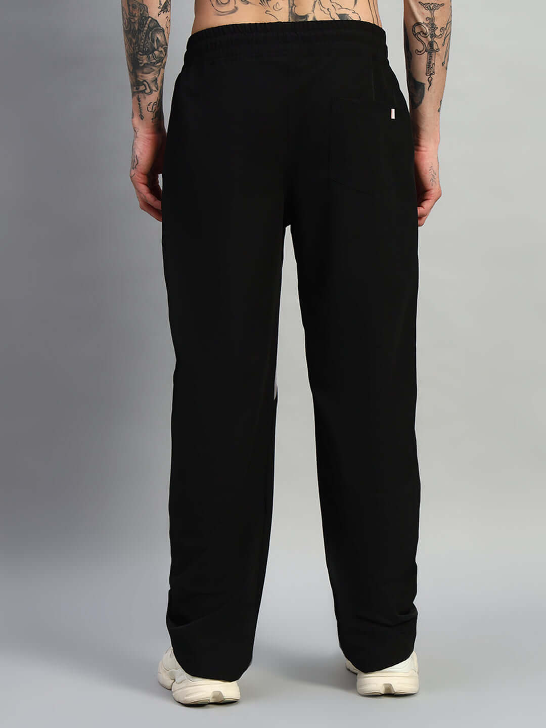 Back view of Ranger Relaxed Fit Black Cargo Pants worn by model, showcasing detailed tailoring and comfortable waistband.