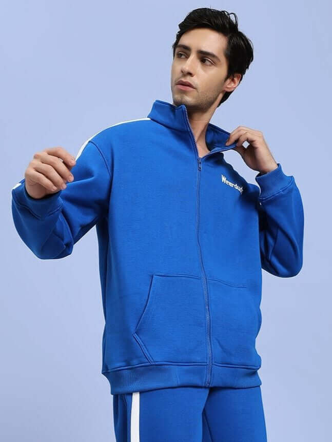 Man wearing RAPID STRIDE COTTON FLEECE JACKET ROYAL BLUE, showcasing stylish and comfortable outerwear for athletic activities.