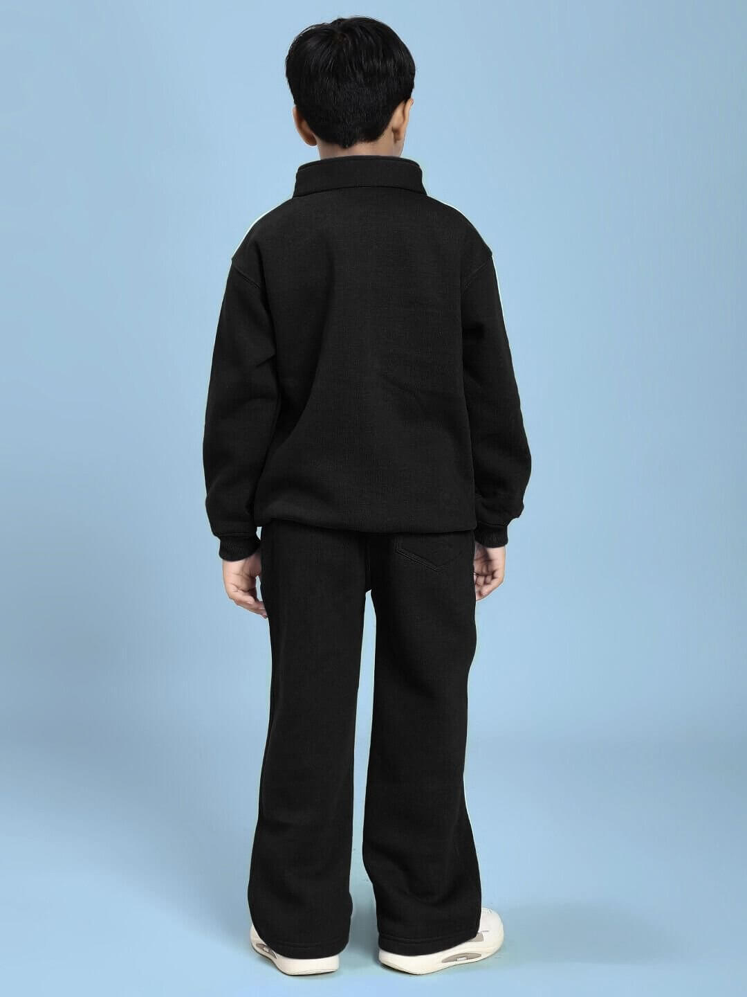 Child wearing RAPID STRIDE FLEECE CO-ORD FOR BOYS AND GIRLS BLACK, showing back view of matching black jacket and joggers.