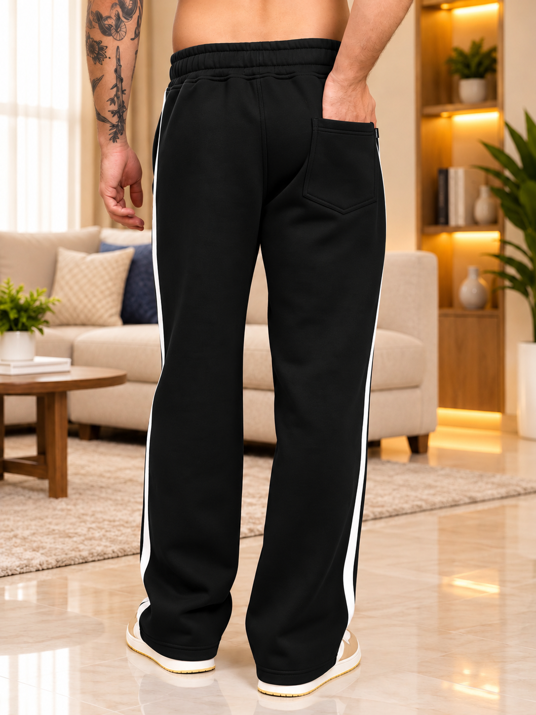 RAPID STRIDE FLEECE JOGGER BLACK with side stripes, back view, worn by man in modern living room