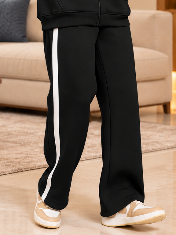 RAPID STRIDE FLEECE JOGGER BLACK with white side stripe, styled with sneakers for a comfy casual look